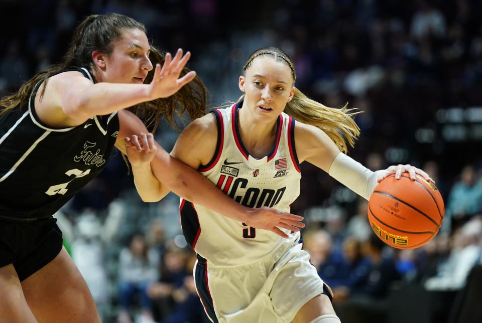 UConn guard Paige Bueckers drives the ball against Providence guard Brynn Farrell during a game in March at Mohegan Sun Arena.