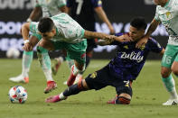 Club Leon's Santiago Colombatto, left, and Seattle Sounders' Raul Ruidiaz, right, battle for the ball during the first half of the Leagues Cup soccer final Wednesday, Sept. 22, 2021, in Las Vegas. (AP Photo/John Locher)