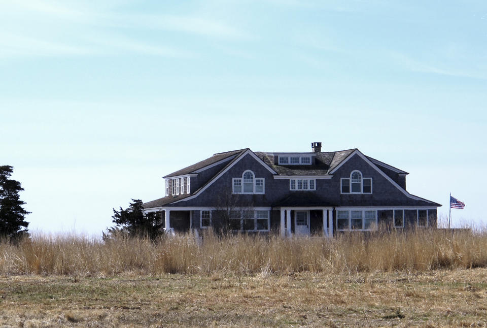 In this April 2, 2019 photo, a multimillion-dollar home sits on a peninsula in Old Saybrook, Conn. The home is among more than 900 structures on the East Coast that would become newly eligible for federal disaster aid, under a proposed remapping of coastal protection zones by the U.S. Fish & Wildlife Service (AP Photo/Dave Collins)