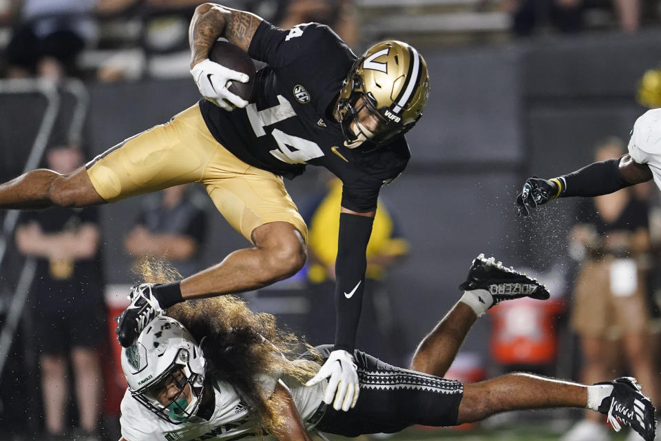 Vanderbilt wide receiver Will Sheppard (14) is stopped by Hawaii defensive back Peter Manuma during the second half of an NCAA college football game Saturday, Aug. 26, 2023, in Nashville, Tenn. Vanderbilt won 35-28. (AP Photo/George Walker IV)