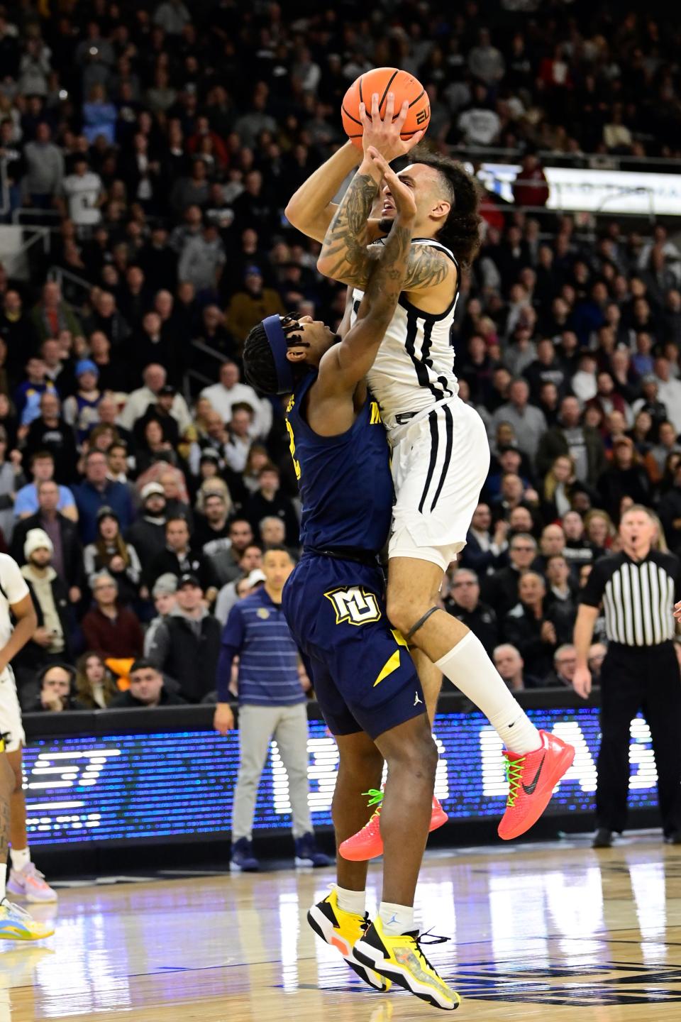 Providence guard Devin Carter is fouled by Marquette's Chase Ross.