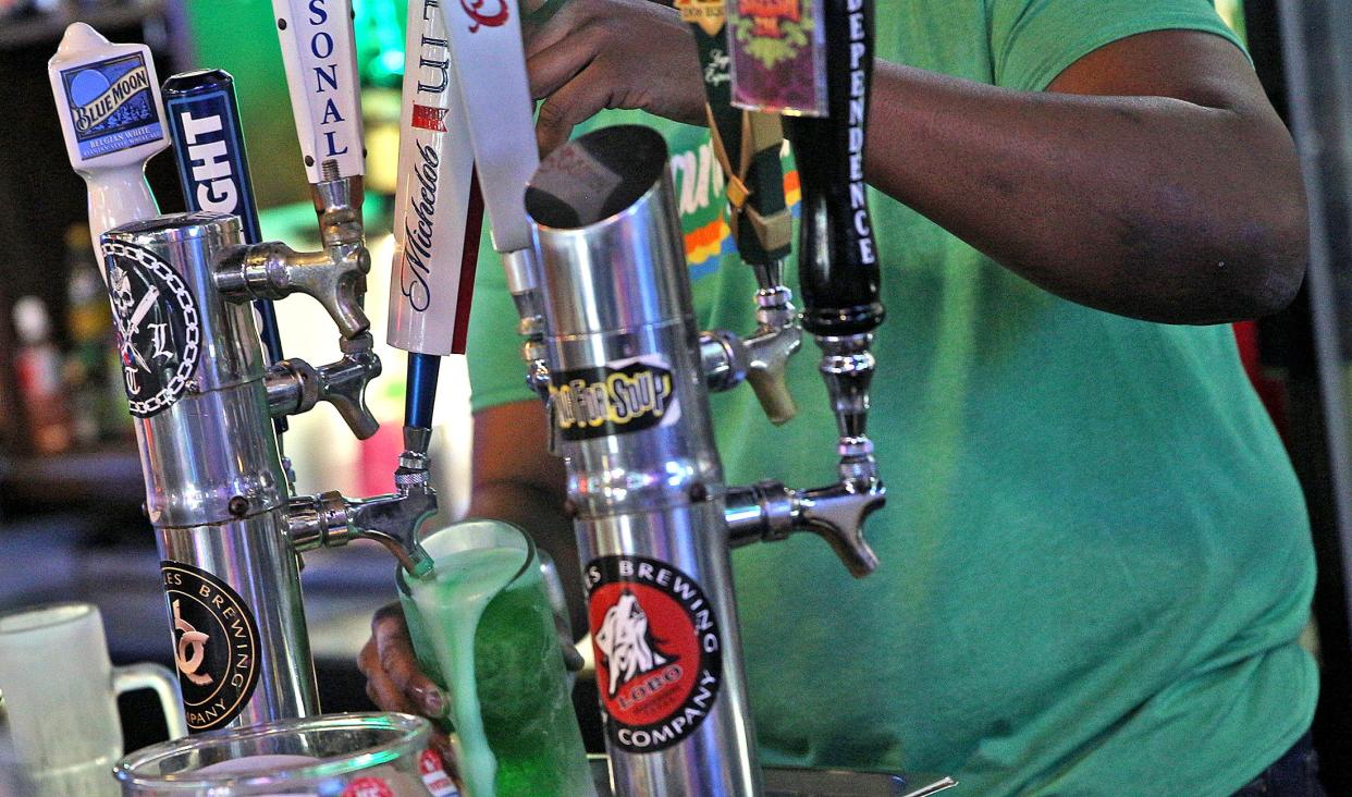 Jerrell Jones pours a green beer at Shenanigans Sports Bar for St. Patrick's Day on Wednesday, March 17, 2021.