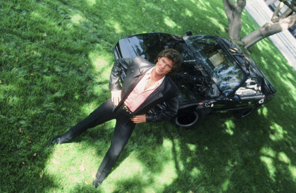 David Hasselhoff as Michael Knight, posing robotically next to his futuristic talking car, KITT (Photo credit: Paul Drinkwater/NBCU Photo Bank/NBCUniversal via Getty Images via Getty Images)