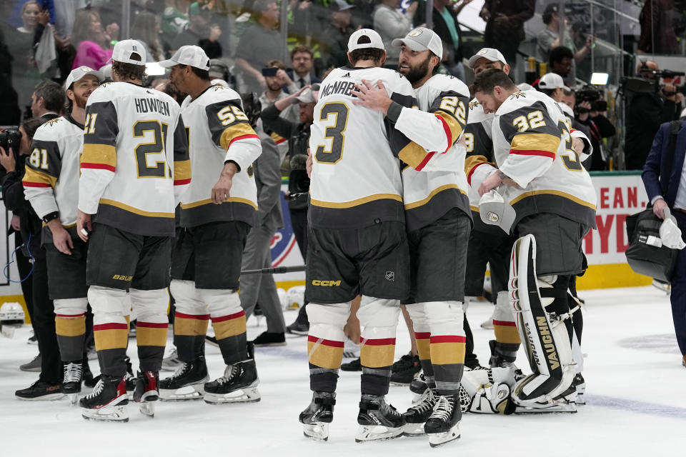 Vegas Golden Knights' Brayden McNabb (3), Michael Amadio (22) and the rest of the team celebrate their win in Game 6 of the NHL hockey Stanley Cup Western Conference finals against the Dallas Stars, Monday, May 29, 2023, in Dallas. (AP Photo/Tony Gutierrez)