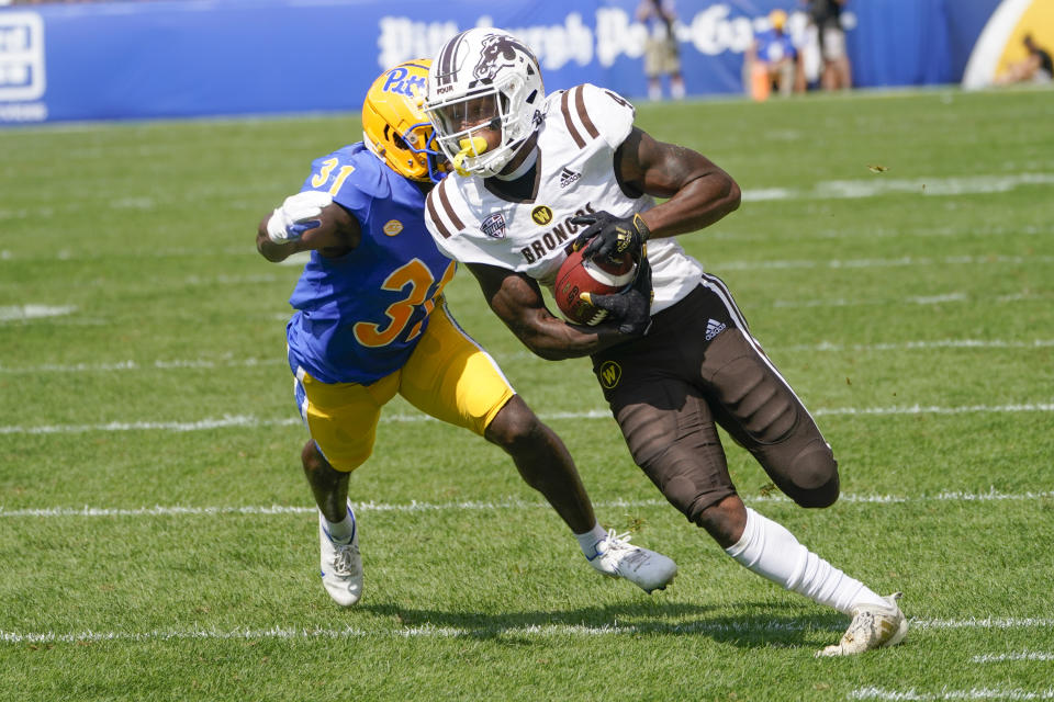 Western Michigan wide receiver Corey Crooms (4) runs away from Pittsburgh defensive back Erick Hallett (31) after making a catch during the first half of an NCAA college football game, Saturday, Sept. 18, 2021, in Pittsburgh. (AP Photo/Keith Srakocic)