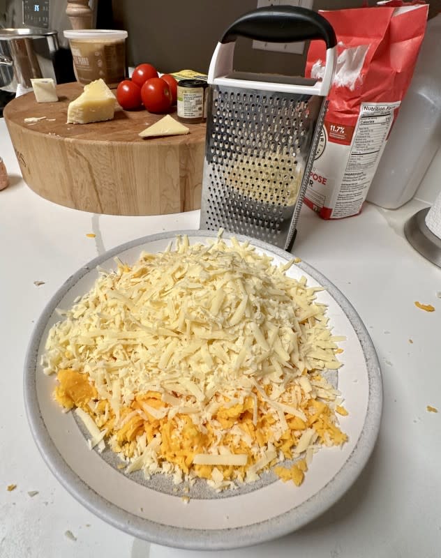 A heaping mound of grated Gruyère and cheddar cheese<p>Kelli Acciardo</p>