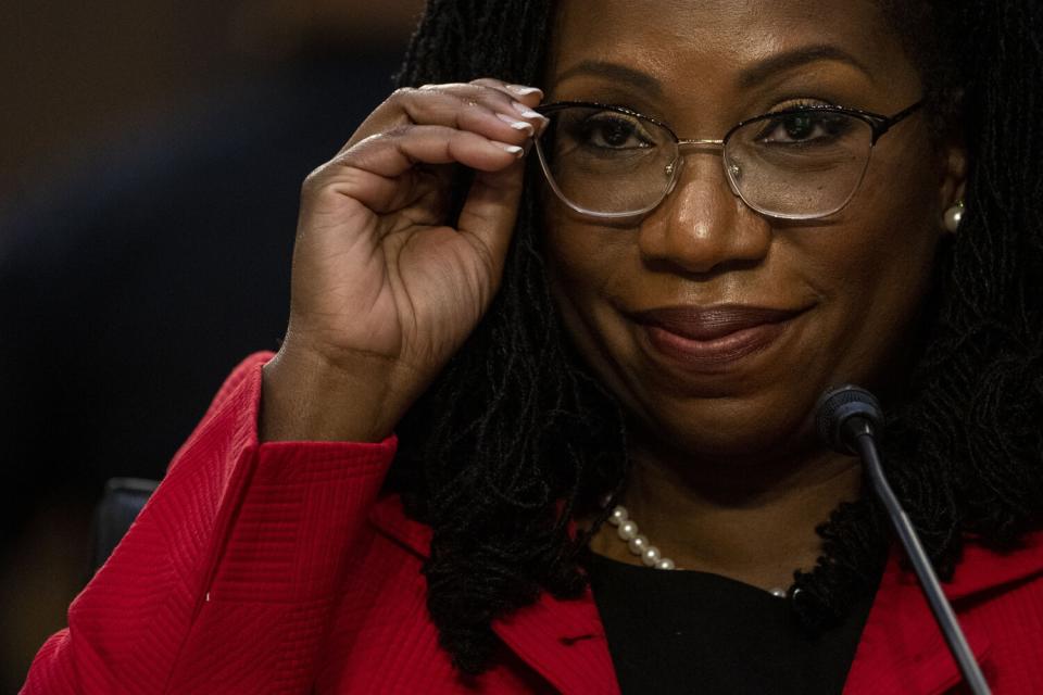 Supreme Court nominee Ketanji Brown Jackson adjusts her glasses.