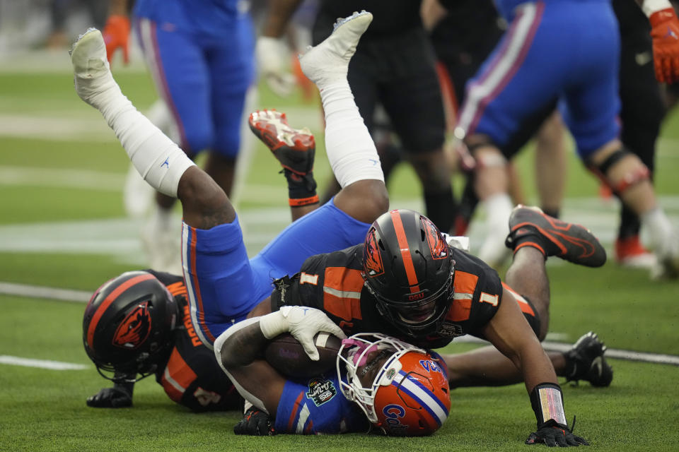 Oregon State linebacker Omar Speights (1) tackles Florida running back Trevor Etienne (7) during the first half of the Las Vegas Bowl NCAA college football game Saturday, Dec. 17, 2022, in Las Vegas. (AP Photo/John Locher)