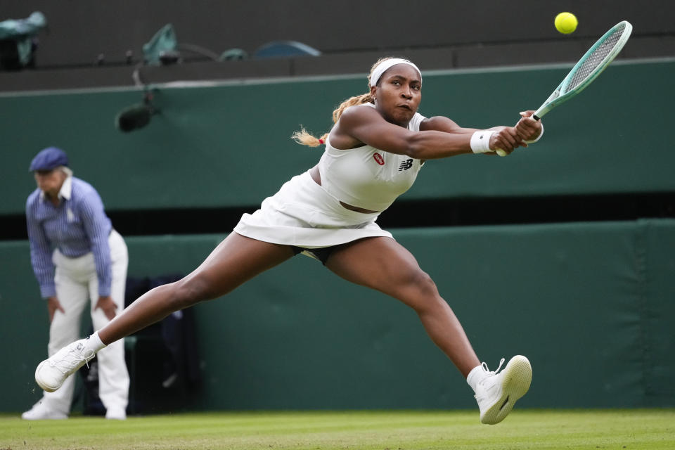 Coco Gauff of the United States plays a backhand return to Sonay Kartal of Britain during their third round match at the Wimbledon tennis championships in London, Friday, July 5, 2024. (AP Photo/Kirsty Wigglesworth)