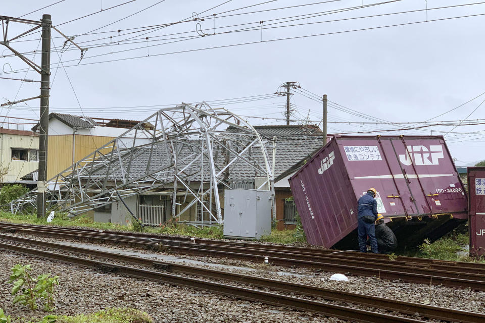 A cargo container and a steel tower are damaged by winds after Typhoon Tapah hit Nobeoka, Miyazaki prefecture, southwestern Japan Sunday, Sept. 22, 2019. The powerful typhoon is heading northeast to Japan's main island of Honshu after lashing parts of the country's southern islands with heavy rains and winds that caused flooding and some minor injuries. (Kyodo News via AP)