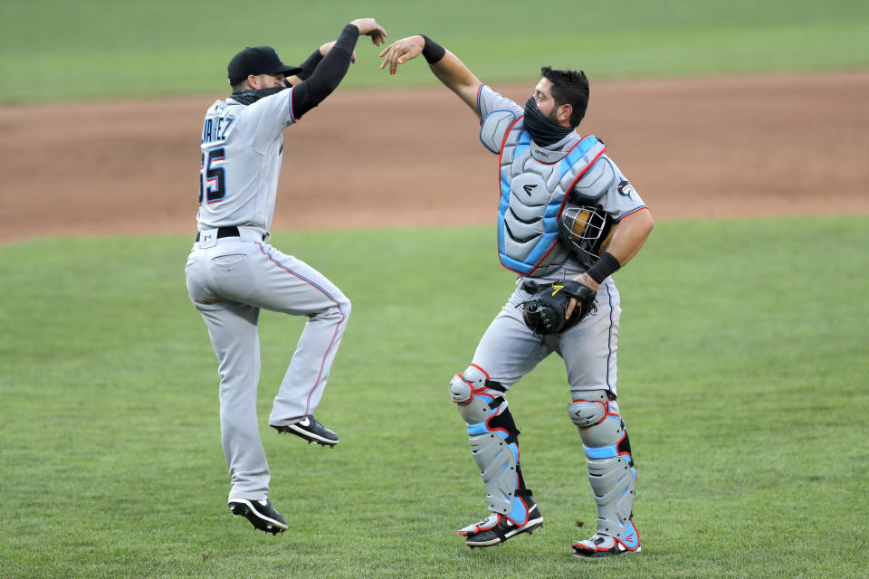 Miami Marlins catcher Francisco Cervelli, right, and second baseman Eddy Alvarez celebrate after defeating the Baltimore Orioles 1-0 during game one of a baseball double-header, Wednesday, Aug. 5, 2020, in Baltimore. (AP Photo/Julio Cortez)