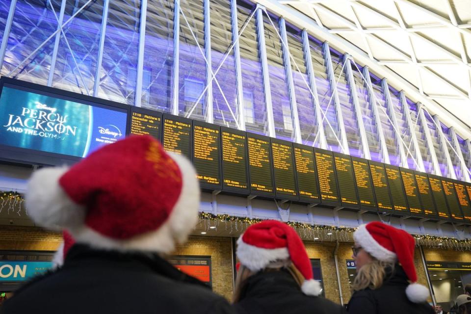 Passengers looking at departure boards at Kings Cross station, London, which is now completely closed for engineering work (PA)