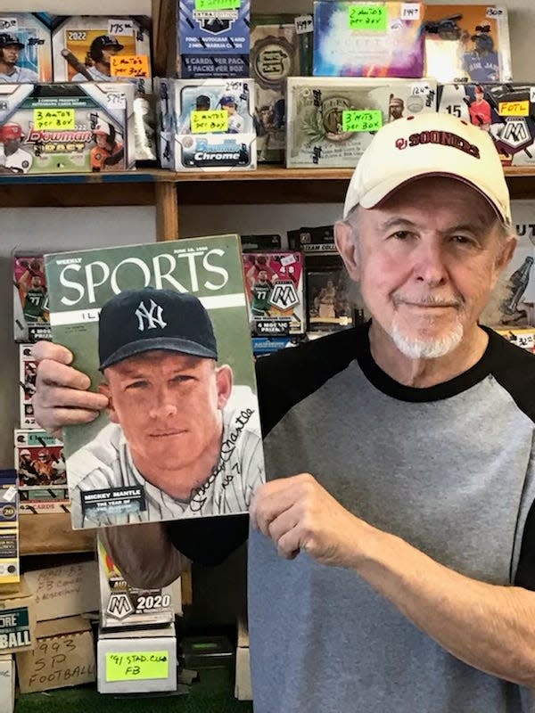 Alan Marchese holds a 1956 Sports Illustrated with Mickey Mantle on the cover.