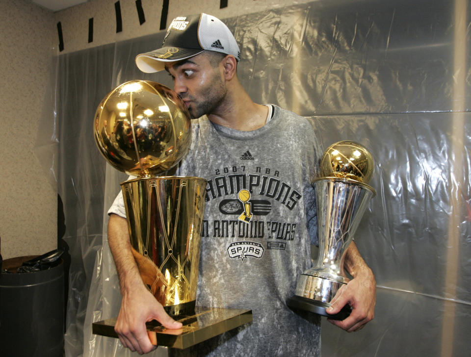 San Antonio Spurs point guard Tony Parker kisses the Larry O'Brien Trophy while holding his MVP trophy after defeating the Cleveland Cavaliers to win the 2007 NBA Finals. (Lucy Nicholson/Reuters)
