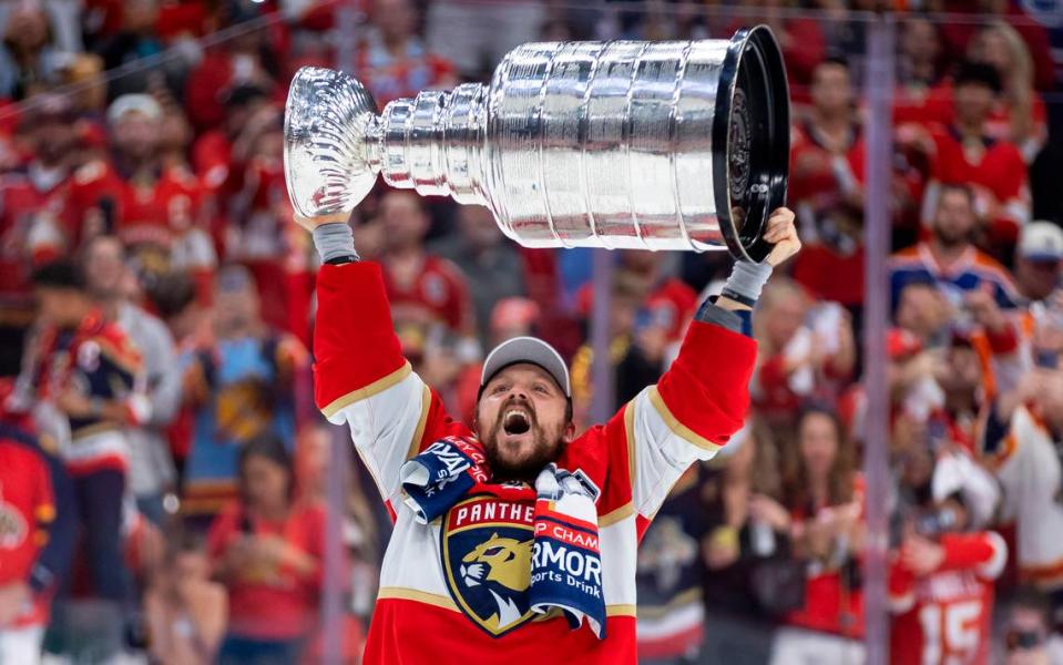 Florida Panthers center Sam Reinhart (13) lifts the cup in celebration after the game.