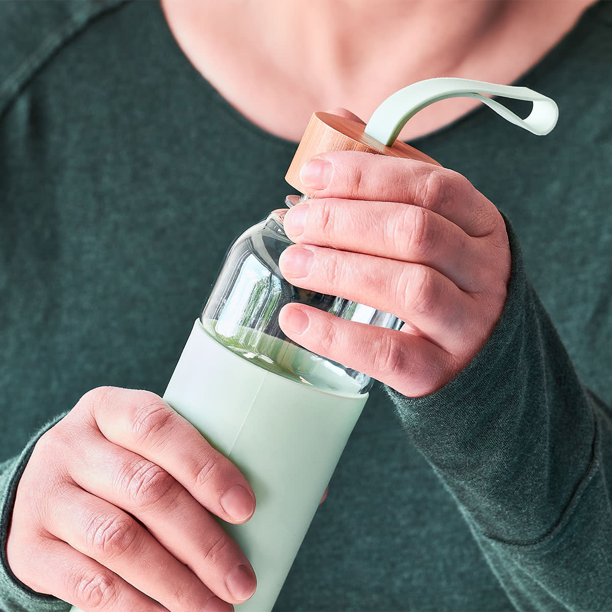 woman holding glass bottle