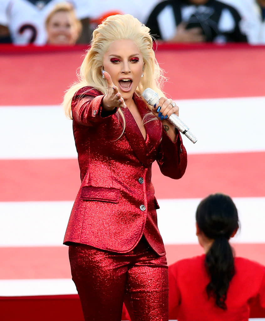 Lady Gaga gave off a red glare as she sang the national anthem before the game. Not only did she score a touchdown for her performance, that outfit, including the eye shadow, was good for an extra point. (Photo: Getty Images)