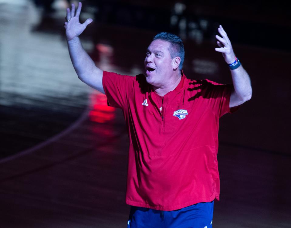 USI Women’s Basketball Head Coach Rick Stein hypes up the crowd as he takes the court with the team during the USI Midnight Madness event at Screaming Eagles Arena in Evansville, Ind., Thursday evening, Oct. 20, 2022. 