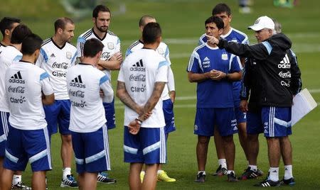 Argentina's national soccer team coach Alejandro Sabella (R) gestures as he talks to players during a training session ahead of their 2014 World Cup final match against Germany in Vespasiano, July 10, 2014. REUTERS/Marcos Brindicci