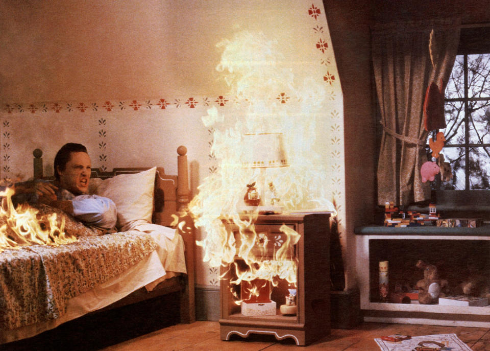 Christopher Walken in a bed that is going up in flames