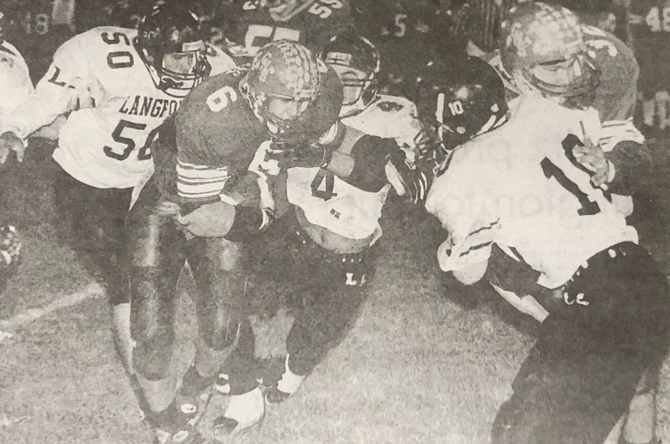 Castlewood's Brent Bass (6) follows the block of teammate Adam Lauseng (32) during a 1996 Class 9B football playoff win over Langford in Castlewood. Bass rushed for 254 yards and six touchdowns in Castlewood's 76-36 win.