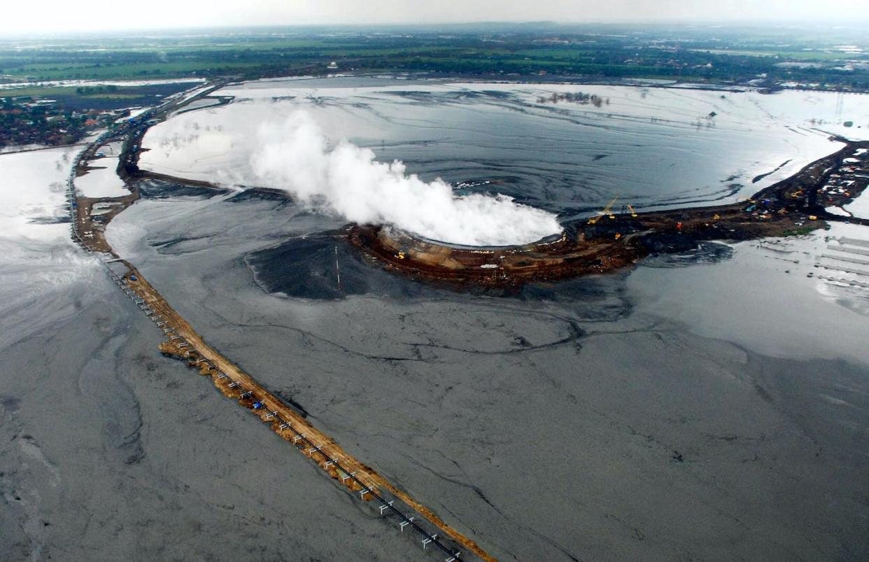 Engineers have tried to corral a mud volcano in Indonesia that has covered more than 1,700 acres with mud. <a href="https://www.gettyimages.com/detail/news-photo/this-aerial-picture-taken-10-march-2007-shows-mud-that-news-photo/73549446?phrase=Eka%20Dharma&adppopup=true" rel="nofollow noopener" target="_blank" data-ylk="slk:Eka Dharma/AFP via Getty Images;elm:context_link;itc:0;sec:content-canvas" class="link ">Eka Dharma/AFP via Getty Images</a>