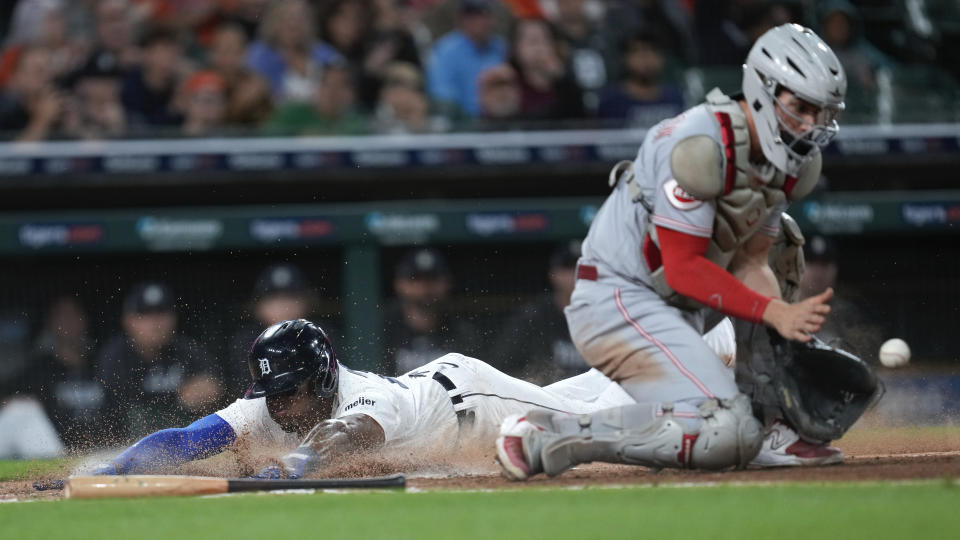 Detroit Tigers' Andy Ibanez slides safely into home plate as Cincinnati Reds catcher Tyler Stephenson (37) receives a late throw in the fifth inning of a baseball game, Tuesday, Sept. 12, 2023, in Detroit. (AP Photo/Paul Sancya)