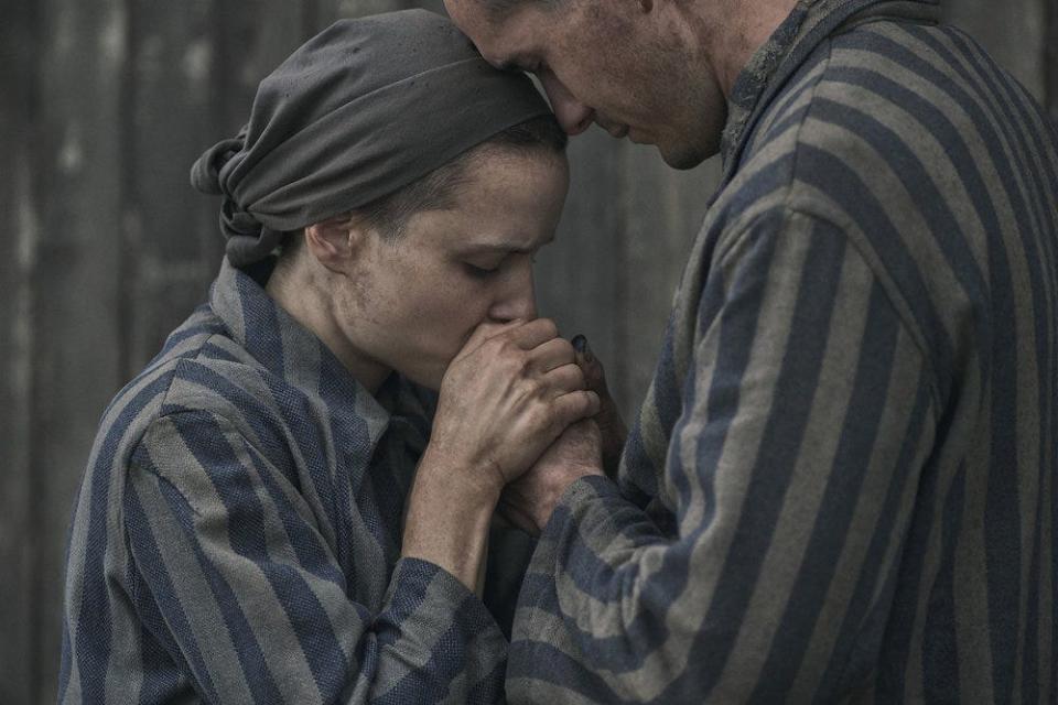 Gita (Anna Próchniak, left) and Lali (Jonah Hauer-King) share a tender moment in Peacock's "The Tattooist of Auschwitz."