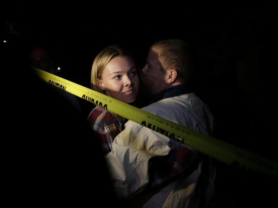 Teylor Whittler is hugged by her father after she fled the Borderline Bar (EPA)