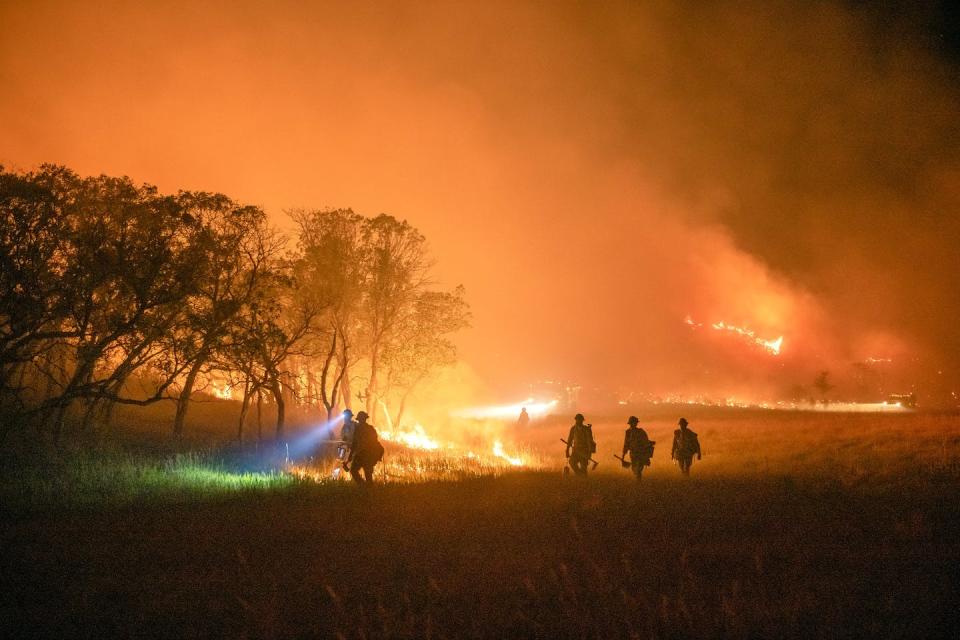 A Wyoming Hotshots crew conducts night operations on the Pine Gulch fire in Colorado in August 2020. <a href="https://www.flickr.com/photos/nifc/50321123752" rel="nofollow noopener" target="_blank" data-ylk="slk:Kyle Miller, Wyoming Hotshots, USFS;elm:context_link;itc:0;sec:content-canvas" class="link ">Kyle Miller, Wyoming Hotshots, USFS</a>