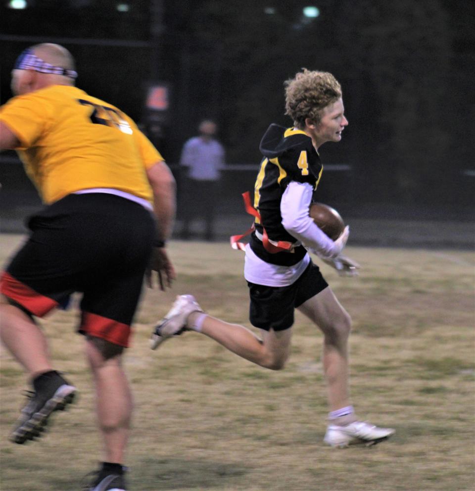 Bellevue freshman Jordan Pendleton runs for a touchdown as Bellevue's varsity football team played a flag football game against members of the Bellevue police department and other adults Friday.