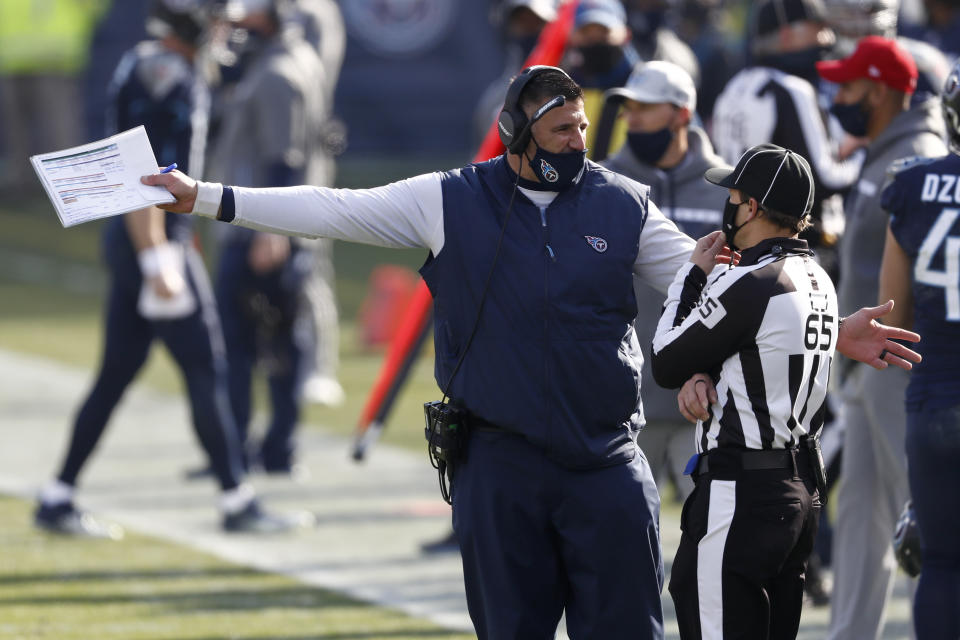 Tennessee Titans head coach Mike Vrabel talks with line nudge Walt Coleman IV (65) in the first half of an NFL wild-card playoff football game against the Baltimore Ravens Sunday, Jan. 10, 2021, in Nashville, Tenn. (AP Photo/Wade Payne)