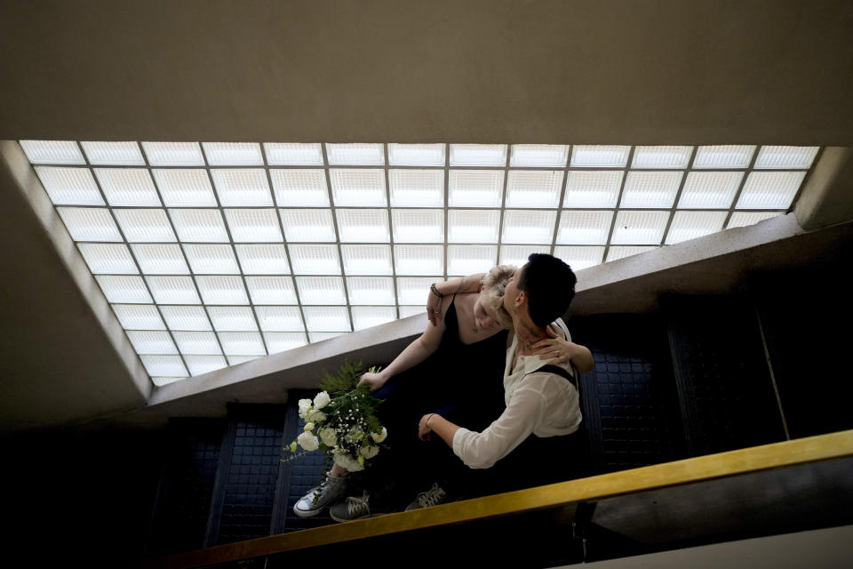 Newlyweds Nadezhda Skvortosova, left, and Tatiana Skvortosova, pose for their wedding photographer during a photo session in Buenos Aires, Argentina, Friday, April 28, 2023. The same-sex couple who got married at a civil registry less than a month after moving to Buenos Aires, had changed their last names in Russia so they could pretend to be sisters. Over the past decade, living openly as a member of the LGBTQ+ community in Russia has grown increasingly difficult. (AP Photo/Natacha Pisarenko)