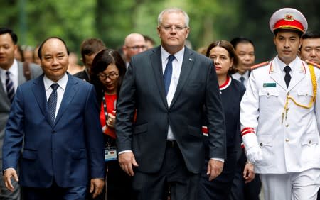 Australia's Prime Minister Scott Morrison and his Vietnamese counterpart Nguyen Xuan Phuc walk together after a welcoming ceremony in Hanoi