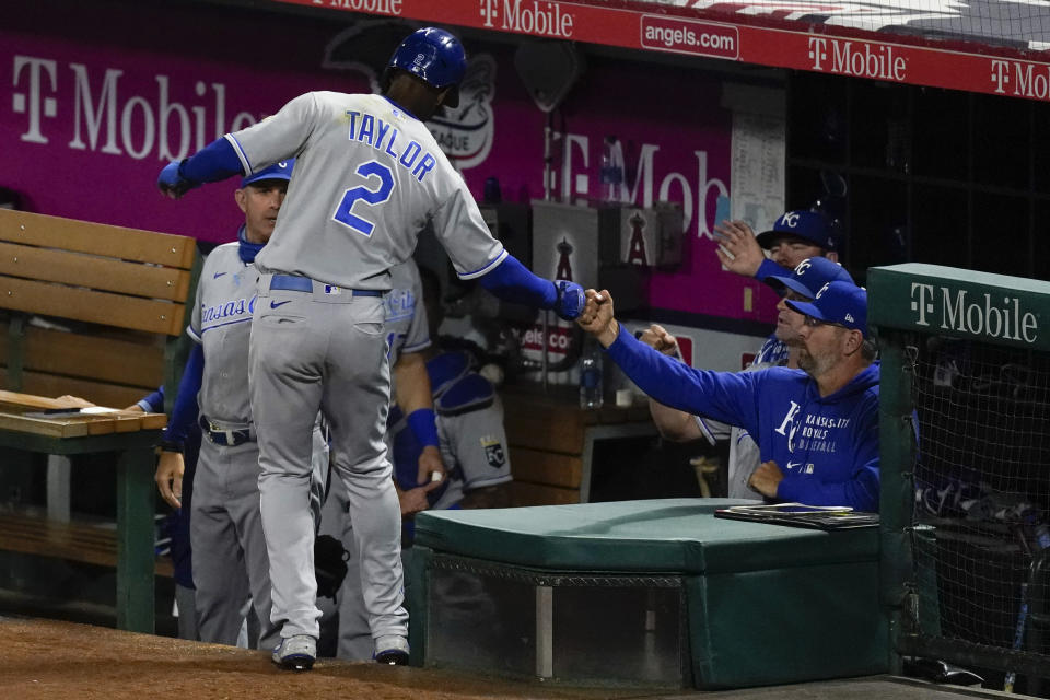 Kansas City Royals' Michael A. Taylor (2) returns to the dugout after scoring off of double hit by Hanser Alberto during the seventh inning of a baseball game against the Los Angeles Angels Tuesday, June 8, 2021, in Los Angeles, Calif. (AP Photo/Ashley Landis)