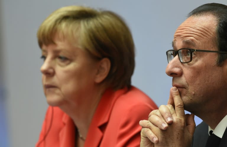 German Chancellor Angela Merkel (left) and French President Francois Hollande attend the Petersberg Climate Dialogue conference in Berlin on May 19, 2015