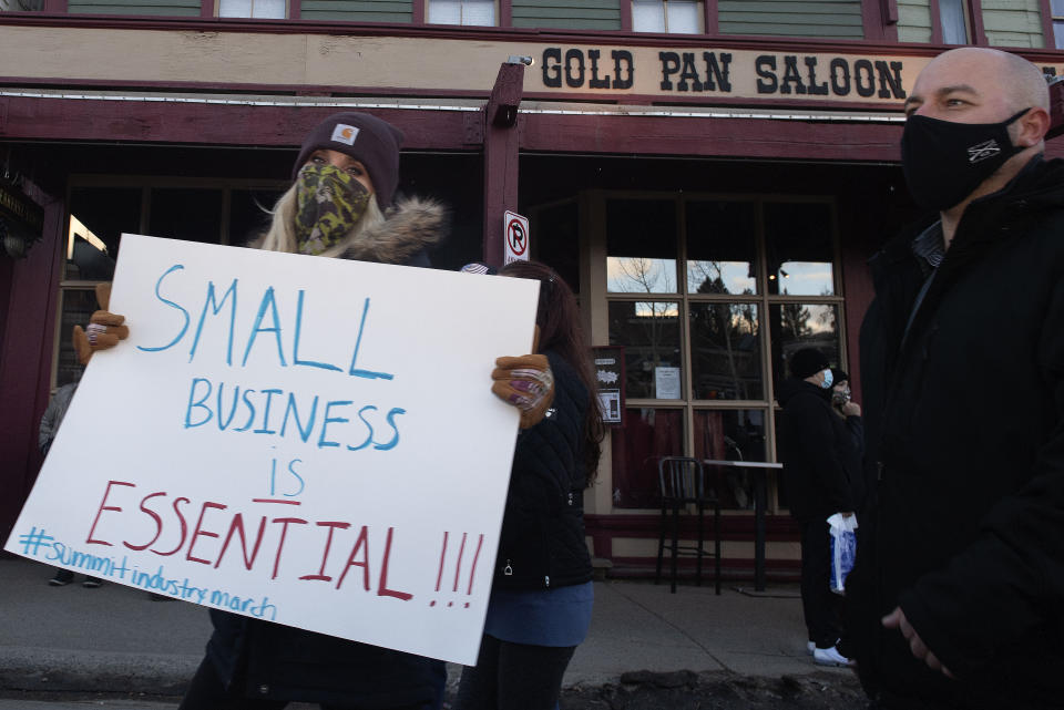 Summit County service industry workers march past the Gold Pan Saloon while protesting the prohibition of in-person dining at restaurants Monday, Nov. 23, 2020 in Breckenridge, Colo. (Jason Connolly/Summit Daily News via AP)