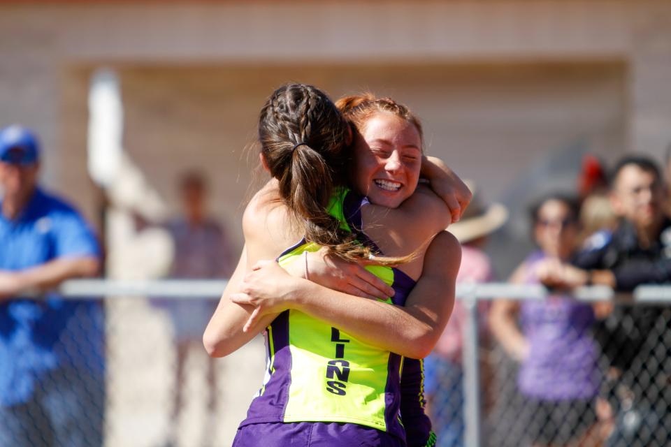 Ozona's Kelyn Gass and McKenna Luckie embrace after qualifying for the area meet in the 100 hurdles at the District 7-2A track meet at Bronco Stadium in Sonora on Apr. 4, 2024.