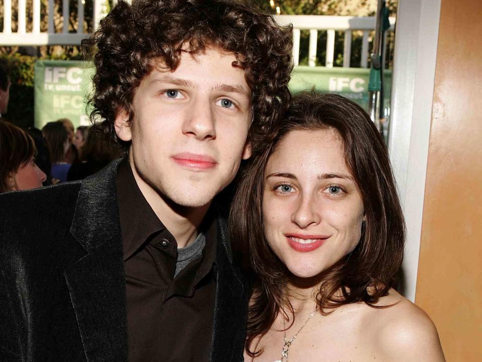 <p>Frazer Harrison/Getty</p> Jesse Eisenberg and Anna Strout pose at the IFC