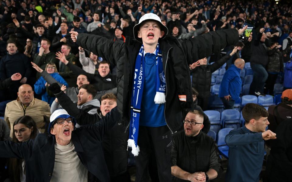 Fans of Everton celebrate after the team's victory in the Premier League match between Everton FC and Liverpool FC