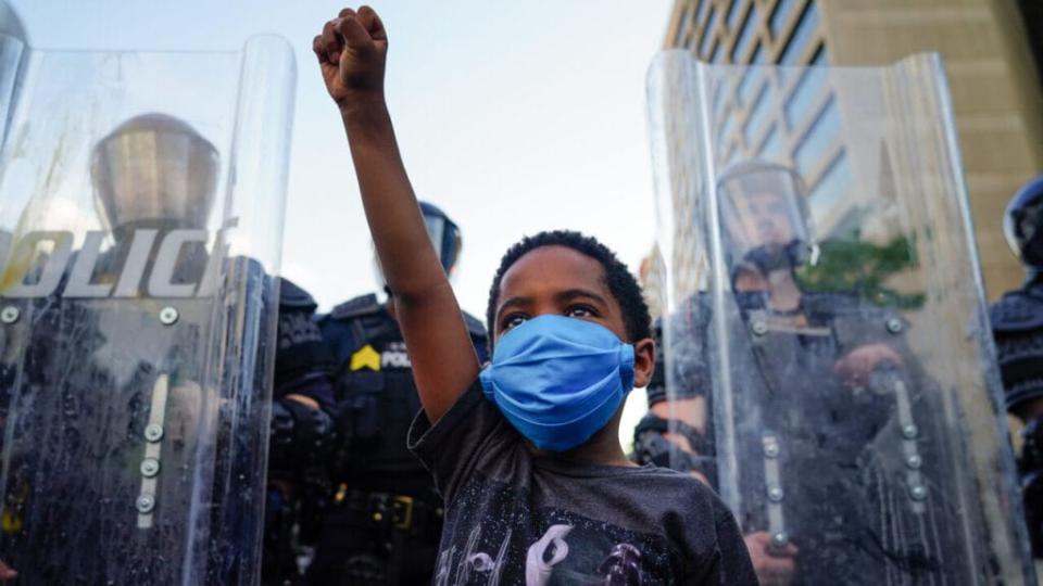 Boy police Black Lives Matter protest x theGrio