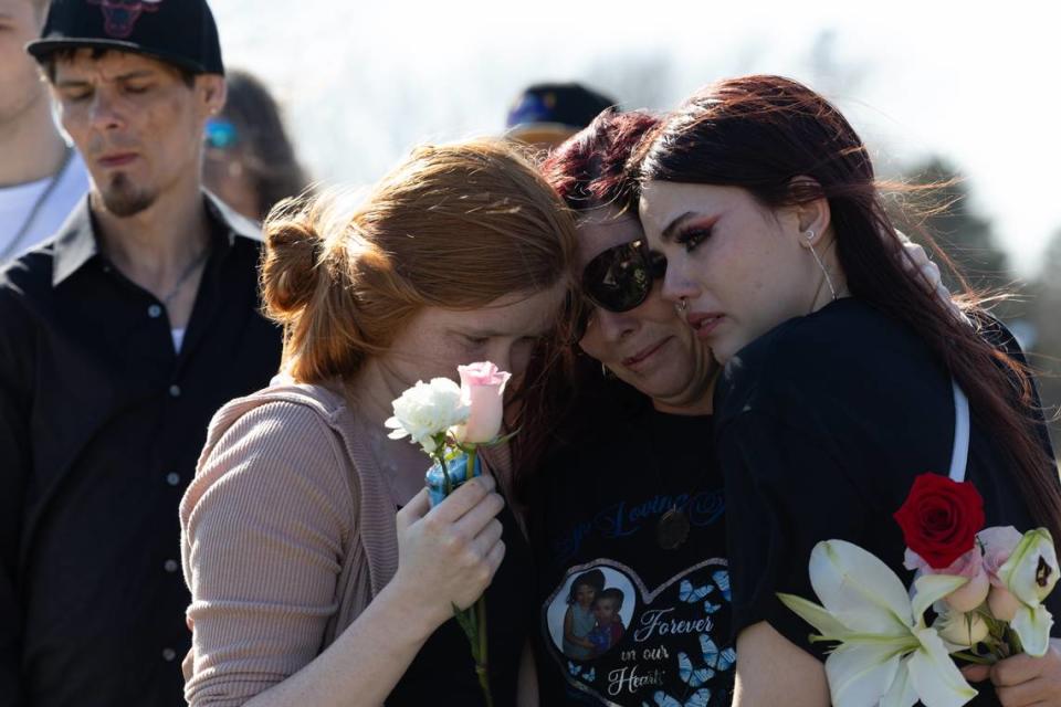 Family of Sharli Edmonds and Chad Metcalf, who died in a house fire Feb. 24 in Cahokia Heights, Ill., find comfort in one another while the casket is lowered at Cedar Hill cemetery in Cedar Hill, MO. Joshua Carter/Belleville News-Democrat