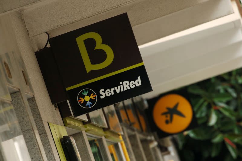Bankia and Caixabank's logotypes are seen in Barcelona