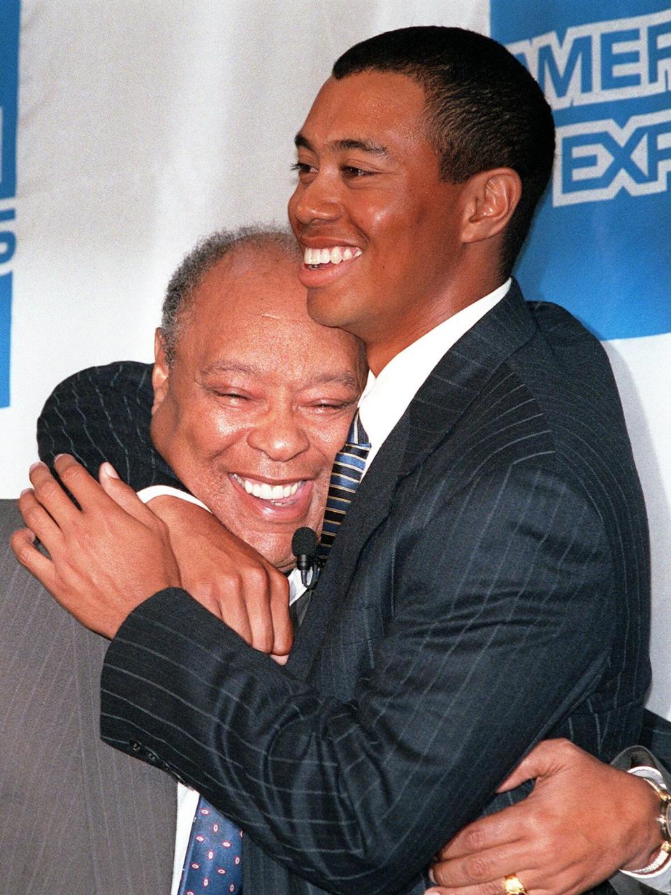 Tiger Woods hugs his father Earl 19 May during an American Express press conference in New York