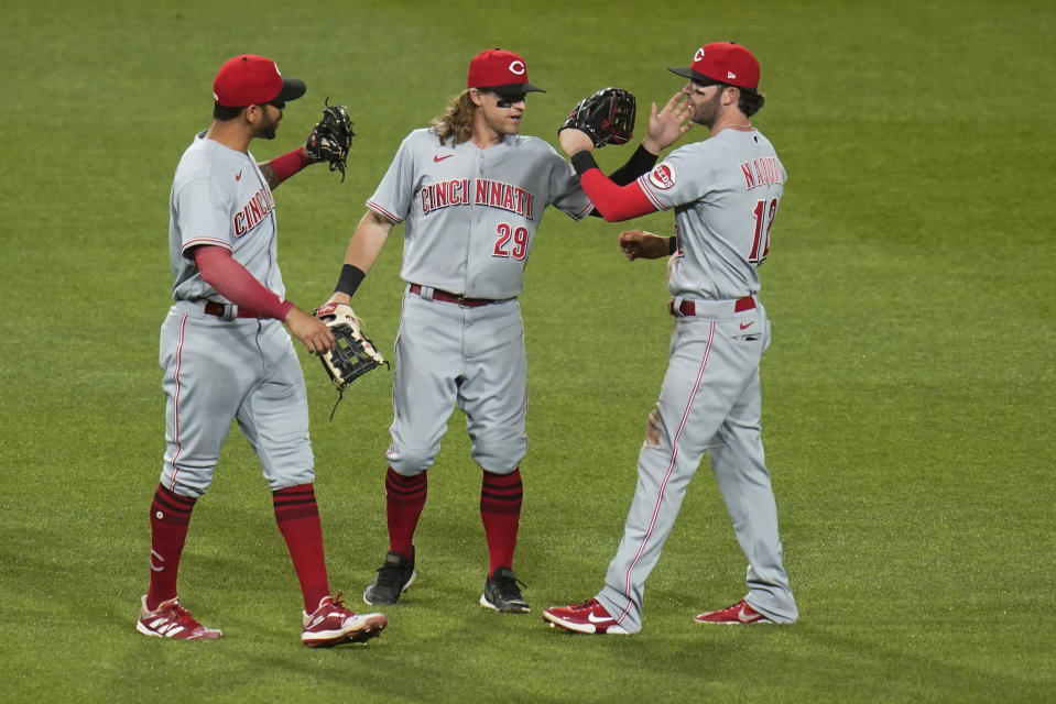 Cincinnati Reds outfielders Tommy Pham, left, TJ Friedl (29) and Tyler Naquin (12) celebrate after the Reds defeated the Pittsburgh Pirates in a baseball game Thursday, May 12, 2022, in Pittsburgh. The Reds won 4-0. (AP Photo/Keith Srakocic)