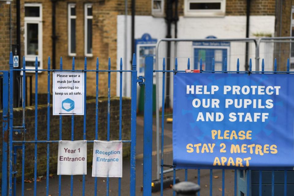 Signage reminding people to wear a mask or face covering and to keep 2-metres apart because of the coronavirus pandemic (AFP via Getty Images)