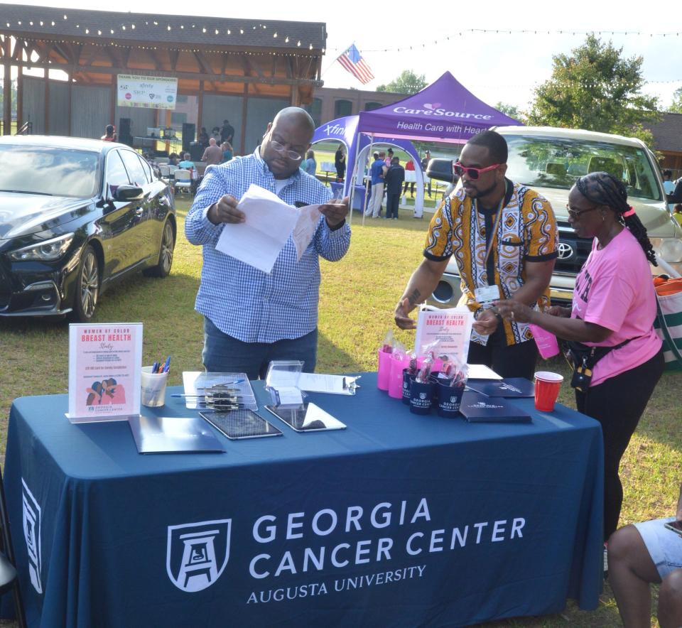 Vendors hand out health care service information at the event.