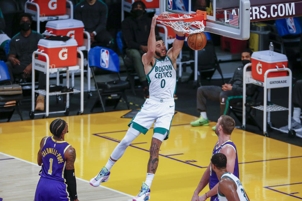 Boston Celtics' Jayson Tatum (0) dunks against the Los Angeles Lakers during the second half of an NBA basketball game Thursday, April 15, 2021, in Los Angeles. (AP Photo/Ringo H.W. Chiu)