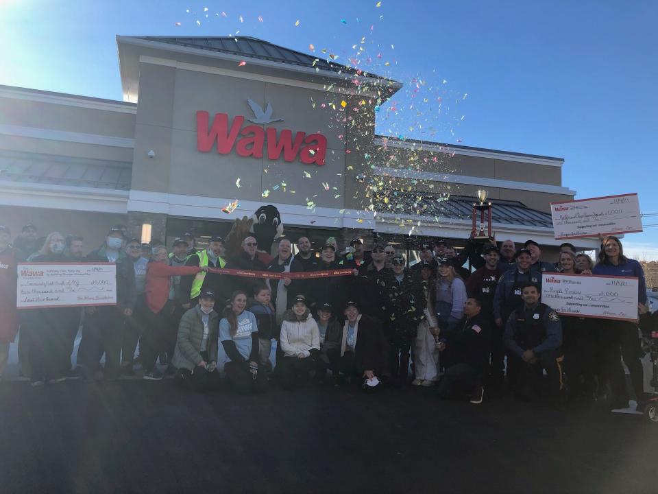 Confetti flies as Wawa executives and employees, along with local government officials and first responders, celebrate the grand opening of the convenience store on Route 15 South in Jefferson Thursday, Nov. 4, 2021.