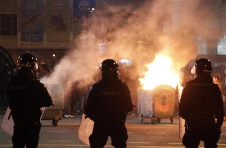 Police stand in front of anti-government protesters in Sarajevo February 6, 2014. REUTERS/Dado Ruvic